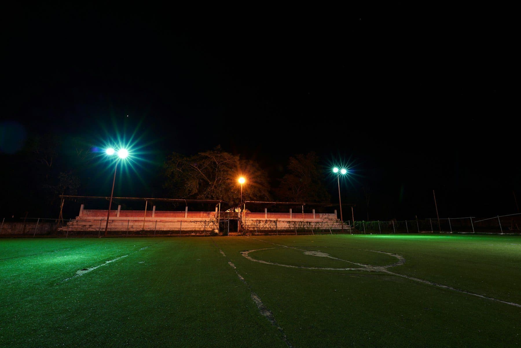 A neighbourhood pitch with the floodlights on